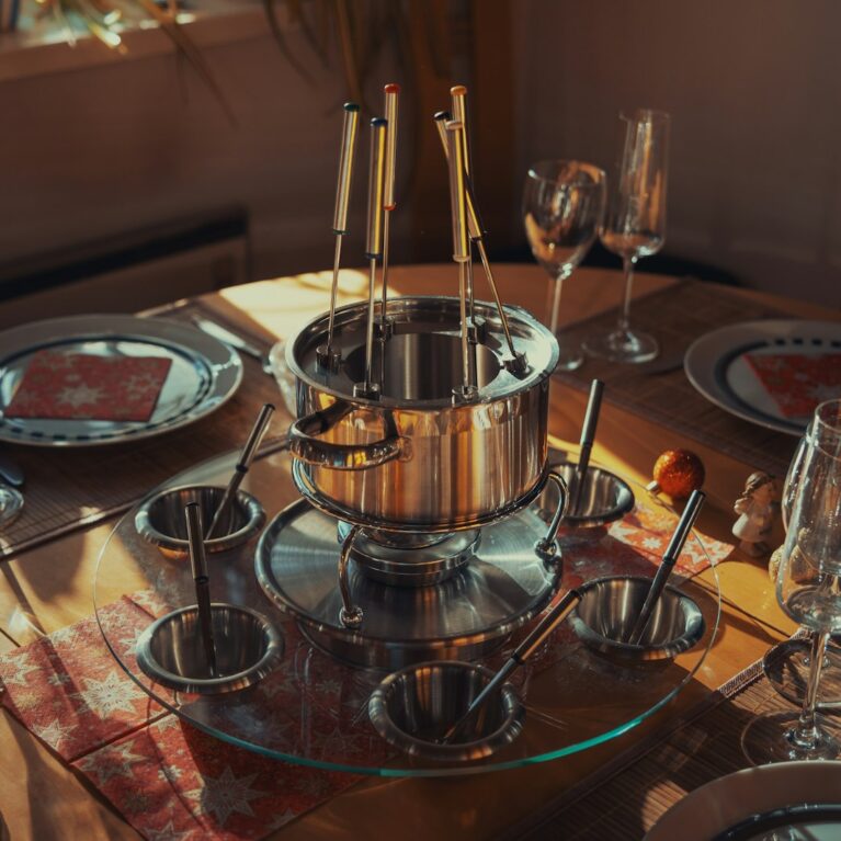 a table set for a meal with silverware and wine glasses